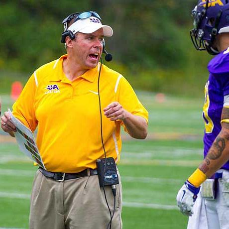 Bob Rankl talking to a football player